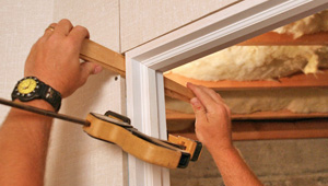 Installing trim and finishing touches to a remodeled basement in Jamestown, NY